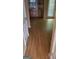 View of the kitchen from the hallway, featuring wood-look floors and natural light at 2590 Wellington Walk Pl, Lithonia, GA 30058