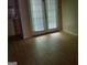 Living room with wood floors, a glass door and window covered by blinds at 2590 Wellington Walk Pl, Lithonia, GA 30058