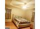 Bright bedroom with wood floors and ceiling fan at 6709 Biscayne Blvd, Rex, GA 30273