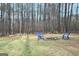 Wooded backyard with fire pit and chairs at 140 Alford Dr, Fayetteville, GA 30215