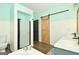 Spa-like bathroom with dual vanities, a soaking tub, and a walk-in shower at 140 Alford Dr, Fayetteville, GA 30215