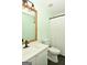 Modern bathroom with a white vanity, large mirror, and updated fixtures at 140 Alford Dr, Fayetteville, GA 30215