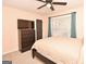 Spacious bedroom with a dresser, large bed and ceiling fan at 140 Alford Dr, Fayetteville, GA 30215