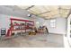 Garage with shelving unit, workbench, and lawnmower at 140 Alford Dr, Fayetteville, GA 30215