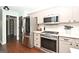 Stylish kitchen with stainless steel appliances and white shaker cabinets at 140 Alford Dr, Fayetteville, GA 30215