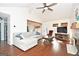 Cozy living room features a sectional sofa, hardwood floors, fireplace, and a large TV at 140 Alford Dr, Fayetteville, GA 30215