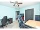 Functional home office featuring a desk, two chairs, and a large TV at 140 Alford Dr, Fayetteville, GA 30215