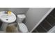 Small bathroom with pedestal sink, toilet, and storage closet at 1340 Napa Valley Dr, Lawrenceville, GA 30045