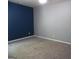 Bedroom with blue and gray walls and neutral carpeting at 1340 Napa Valley Dr, Lawrenceville, GA 30045