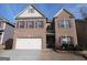 Brick two-story house with a large front yard and two-car garage at 1340 Napa Valley Dr, Lawrenceville, GA 30045