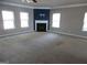 Large living room with fireplace, neutral walls, and carpeting at 1340 Napa Valley Dr, Lawrenceville, GA 30045