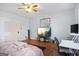 Comfortable bedroom with hardwood floors and a TV at 6051 Reynolds Rd, Morrow, GA 30260