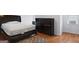 Cozy bedroom with hardwood floors and a dresser at 6051 Reynolds Rd, Morrow, GA 30260