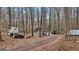 Driveway to house through wooded area with trucks parked at 6051 Reynolds Rd, Morrow, GA 30260