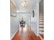 Bright entryway with hardwood floors, chandelier, and view of dining area at 6051 Reynolds Rd, Morrow, GA 30260