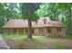 Brick ranch home with covered porch and large yard at 6051 Reynolds Rd, Morrow, GA 30260