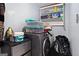 Small laundry room with washer and storage at 6051 Reynolds Rd, Morrow, GA 30260