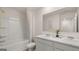 Bright bathroom features double sinks, white marble countertop and a bathtub with shower at 205 Friendship Oak Way, Hampton, GA 30228