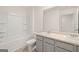 Bright bathroom features a double vanity, neutral color palette, and shower-tub combo at 205 Friendship Oak Way, Hampton, GA 30228
