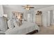 Bright bedroom featuring neutral decor, a ceiling fan, and a view into an ensuite bathroom at 205 Friendship Oak Way, Hampton, GA 30228