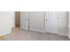 A bedroom with neutral carpet and a pair of interior doors at 205 Friendship Oak Way, Hampton, GA 30228