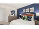Bedroom featuring blue accent wall, neutral carpet, and colorful gaming decor at 205 Friendship Oak Way, Hampton, GA 30228