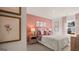Bedroom featuring pink accent wall, neutral carpet, and natural light at 205 Friendship Oak Way, Hampton, GA 30228