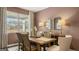 Elegant dining room featuring a wooden table, upholstered chairs, and large windows with a view at 205 Friendship Oak Way, Hampton, GA 30228