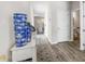 Inviting hallway with wood floors, decorative vases, and a glimpse into a cozy living space at 205 Friendship Oak Way, Hampton, GA 30228