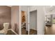 Interior view showcasing a small closet and a view of a powder room and living area at 205 Friendship Oak Way, Hampton, GA 30228