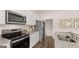 Bright kitchen with stainless steel appliances, white cabinets, and granite countertops at 205 Friendship Oak Way, Hampton, GA 30228