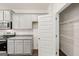 Modern kitchen with light gray cabinets, granite counters, and a convenient pantry at 205 Friendship Oak Way, Hampton, GA 30228