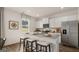 Modern kitchen with stainless steel refrigerator, white cabinets and granite countertops at 205 Friendship Oak Way, Hampton, GA 30228