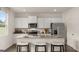 Modern kitchen with white cabinets, granite countertops, stainless steel appliances, and an island at 205 Friendship Oak Way, Hampton, GA 30228