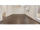 Inviting living area with hardwood floors, stairs, and large windows to the backyard at 205 Friendship Oak Way, Hampton, GA 30228