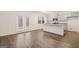 Bright living room with hardwood floors, kitchen island, and French door access at 205 Friendship Oak Way, Hampton, GA 30228