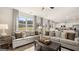 Sun-drenched living room with plush seating and views of the backyard at 205 Friendship Oak Way, Hampton, GA 30228