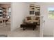 Loft area with modern decor featuring a comfortable seating area and a desk at 205 Friendship Oak Way, Hampton, GA 30228
