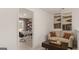 Loft featuring a couch with modern decor adjacent to a flex space with a desk at 205 Friendship Oak Way, Hampton, GA 30228