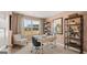 Cozy home office with neutral walls, large window, shelving and light colored carpet for a comfortable workspace at 205 Friendship Oak Way, Hampton, GA 30228