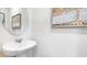 Stylish powder room featuring a round mirror and elegant pedestal sink at 205 Friendship Oak Way, Hampton, GA 30228