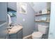 Small bathroom with toilet, sink, and decorative shelving at 165 Nandover Way, Fayetteville, GA 30215