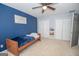 Blue-walled bedroom with a twin bed and ample closet space at 165 Nandover Way, Fayetteville, GA 30215