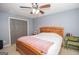 Bedroom with wooden bed frame, nightstand, and ceiling fan at 165 Nandover Way, Fayetteville, GA 30215