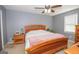 Bedroom with wooden bed frame, nightstand, and ceiling fan at 165 Nandover Way, Fayetteville, GA 30215