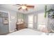 Bright bedroom with a dresser, hanging chair, and large windows at 165 Nandover Way, Fayetteville, GA 30215