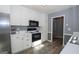Modern kitchen featuring white cabinets, stainless steel appliances, and luxury vinyl flooring at 165 Nandover Way, Fayetteville, GA 30215