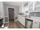 Clean and bright kitchen with white cabinets and stainless steel appliances at 165 Nandover Way, Fayetteville, GA 30215