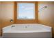 Bathroom with corner bathtub and window at 2171 Grant Ave, Mcdonough, GA 30252