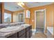 Bathroom with double vanity, lighted mirror, and tub at 2171 Grant Ave, Mcdonough, GA 30252